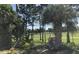 Landscaped backyard with palm trees, small water feature, view of park and playground equipment at 3680 Whiting Se Dr, St Petersburg, FL 33705