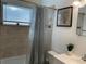 Well-lit bathroom with tiled shower/tub, toilet, and vanity with sink at 3680 Whiting Se Dr, St Petersburg, FL 33705