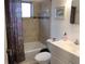 Cozy bathroom featuring a shower-tub combo with tiled walls and a colorful curtain at 3680 Whiting Se Dr, St Petersburg, FL 33705