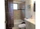 Cozy bathroom featuring a shower-tub combo with tiled walls and a colorful curtain at 3680 Whiting Se Dr, St Petersburg, FL 33705