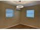 Bedroom with wood-look floors, simple lighting, and mini-split air conditioning at 3680 Whiting Se Dr, St Petersburg, FL 33705
