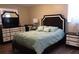 A well-lit bedroom boasts a queen-size bed with blue bedding and light-colored wood-look flooring at 3680 Whiting Se Dr, St Petersburg, FL 33705
