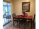 Cozy dining area with wood floors and sliding glass doors to the sunroom at 3680 Whiting Se Dr, St Petersburg, FL 33705