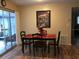 Cozy dining area with wood floors and sliding glass doors to the sunroom at 3680 Whiting Se Dr, St Petersburg, FL 33705