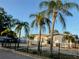 A well-kept single-story residence with a black metal fence, complemented by mature palms and a rock front yard at 3680 Whiting Se Dr, St Petersburg, FL 33705