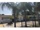 A cozy single-story home featuring palm trees, a white rock lawn, and a secure black metal fence at 3680 Whiting Se Dr, St Petersburg, FL 33705