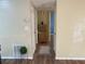 Hallway with wood-look flooring leading to additional rooms with neutral walls at 3680 Whiting Se Dr, St Petersburg, FL 33705