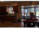 A functional kitchen with cherry wood cabinets, stainless steel appliances, and a view of the sunroom at 3680 Whiting Se Dr, St Petersburg, FL 33705