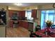 A functional kitchen with cherry wood cabinets, stainless steel appliances, and a view of the sunroom at 3680 Whiting Se Dr, St Petersburg, FL 33705