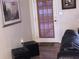 Living room with decor, featuring art, dark furniture, and a bamboo-covered door at 3680 Whiting Se Dr, St Petersburg, FL 33705