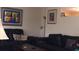 A cozy living room featuring black leather sofas, decorative wall art, and soft ambient lighting at 3680 Whiting Se Dr, St Petersburg, FL 33705