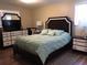 Primary bedroom featuring a large bed, wooden floors, dressers, and soft lighting at 3680 Whiting Se Dr, St Petersburg, FL 33705