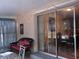 Cozy patio with glass doors, a wicker couch, and string lights for outdoor relaxation at 3680 Whiting Se Dr, St Petersburg, FL 33705