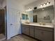 Large bathroom featuring a walk-in glass shower, dual sinks, and modern lighting at 4171 Via Sienna Cir, Sarasota, FL 34243