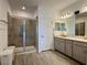 Well-appointed bathroom featuring dual sinks, a glass-enclosed shower, and modern fixtures at 4171 Via Sienna Cir, Sarasota, FL 34243