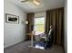 Cozy bedroom with a ceiling fan, curtains, carpet, a desk, and a home office setup at 4171 Via Sienna Cir, Sarasota, FL 34243