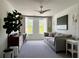 Bright bedroom with modern decor, plush carpet, and large windows providing ample natural light at 4171 Via Sienna Cir, Sarasota, FL 34243