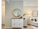Stylish foyer features a decorative mirror, storage cabinet, and flows into the bright and inviting living room at 4171 Via Sienna Cir, Sarasota, FL 34243