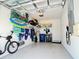 Well-organized garage with epoxy floors, storage racks, and an electric vehicle charger at 4171 Via Sienna Cir, Sarasota, FL 34243