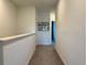 Upstairs hallway featuring neutral carpet, fresh paint, and framed wall art at 4171 Via Sienna Cir, Sarasota, FL 34243