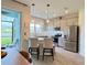 Stylish kitchen featuring stainless steel appliances, a breakfast bar, and serene views of the lake at 4171 Via Sienna Cir, Sarasota, FL 34243