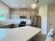 Contemporary kitchen with stainless steel appliances, quartz countertops, and ample cabinet space for storage at 4171 Via Sienna Cir, Sarasota, FL 34243