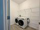 Functional laundry room with modern washer and dryer, plus convenient wire shelving at 4171 Via Sienna Cir, Sarasota, FL 34243