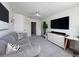 Spacious living room with a plush gray sofa, TV, and modern decor at 4171 Via Sienna Cir, Sarasota, FL 34243
