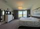 Spacious main bedroom with scenic lake view, plush carpet, and stylish furnishings at 4171 Via Sienna Cir, Sarasota, FL 34243