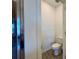 Enclosed toilet room with white toilet and wood look tile at 4171 Via Sienna Cir, Sarasota, FL 34243