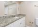 Bathroom with a white vanity, granite countertop, and a large mirror at 3850 11Th S Ave, St Petersburg, FL 33711