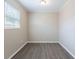Bright and empty bedroom featuring wood-look flooring, neutral paint and one window at 3850 11Th S Ave, St Petersburg, FL 33711