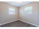 Bright bedroom featuring two windows, wood-look flooring, and neutral-colored walls at 3850 11Th S Ave, St Petersburg, FL 33711