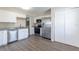 Modern kitchen with stainless steel appliances, white cabinets, and granite countertops at 3850 11Th S Ave, St Petersburg, FL 33711