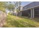 Relaxing backyard area with a screened-in porch and lush greenery at 819 Lucent Sands Ct, Brandon, FL 33511