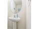 Clean white pedestal sink with oval mirror and blue soap at 819 Lucent Sands Ct, Brandon, FL 33511