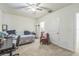 Bright bedroom featuring neutral carpet, a ceiling fan, and plenty of space for a desk and seating at 819 Lucent Sands Ct, Brandon, FL 33511