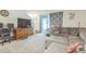 Cozy living room with plush sofa, TV, and natural light from sliding glass door at 819 Lucent Sands Ct, Brandon, FL 33511