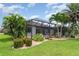 Inviting backyard with a screened-in lanai and meticulously maintained landscaping at 20323 Granlago Dr, Venice, FL 34293