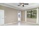 Bedroom featuring hardwood floors, neutral walls, a ceiling fan, and a door leading to the outside at 20323 Granlago Dr, Venice, FL 34293