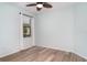 Cozy bedroom featuring new floors, neutral paint, and a window overlooking the manicured yard at 20323 Granlago Dr, Venice, FL 34293