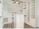 Custom walk-in closet featuring adjustable shelving, drawers, and a vanity area at 20323 Granlago Dr, Venice, FL 34293