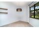 Bright dining room with neutral tile flooring, a decorative light fixture, and a window view of the landscaped backyard at 20323 Granlago Dr, Venice, FL 34293