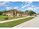 Landscaped yard and sidewalk lead to this house with a 3-car garage and decorative stone details at 20323 Granlago Dr, Venice, FL 34293