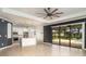Open concept floor plan with a modern kitchen, stainless appliances, and views of the pool at 20323 Granlago Dr, Venice, FL 34293