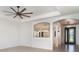 Bright living space with a ceiling fan and views into other rooms via decorative arches at 20323 Granlago Dr, Venice, FL 34293