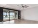 Spacious primary bedroom with a ceiling fan, sliding glass doors to a screened pool and water view at 20323 Granlago Dr, Venice, FL 34293