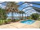 Stunning screened-in pool with a lake view and lush landscaping at 20323 Granlago Dr, Venice, FL 34293