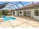 Screened-in pool area with an expansive brick paver deck and tranquil lake views at 20323 Granlago Dr, Venice, FL 34293