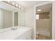 Bathroom featuring a large white sink and an adjoining full bathroom with shower and tub at 1001 Meadowcrest Dr, Valrico, FL 33594